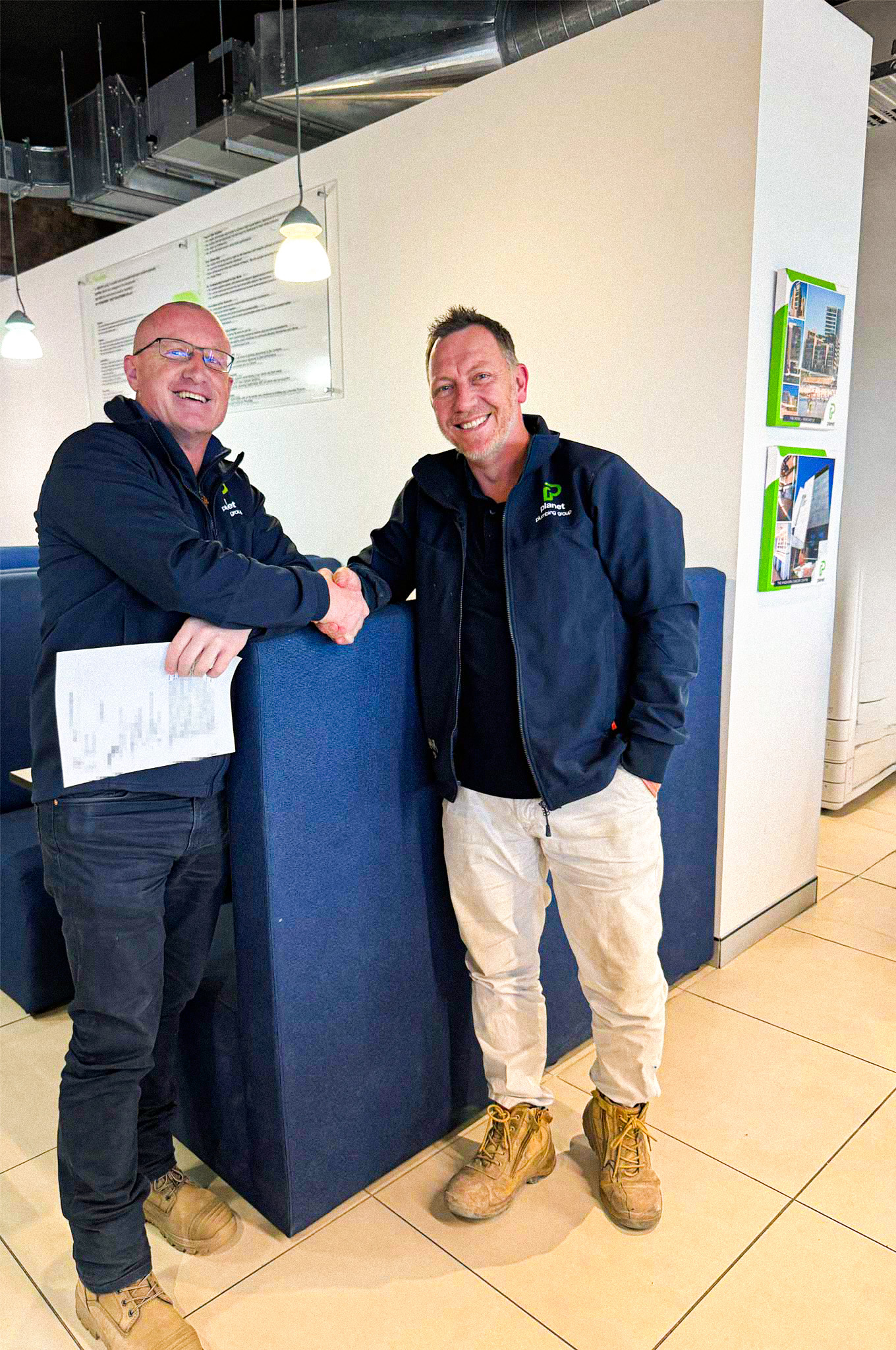 Celebrating 20 Years with Planet Plumbing Andrew shaking Paul hand to congratulate him